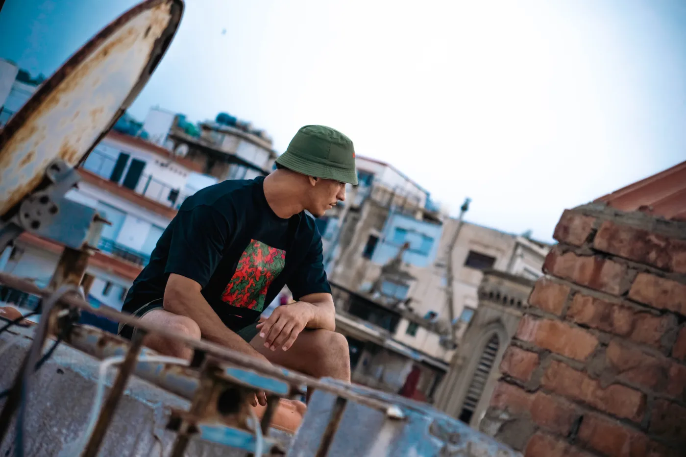 A young man wearing a Bab Dzira T-shirt overlooking the Bay of Algiers